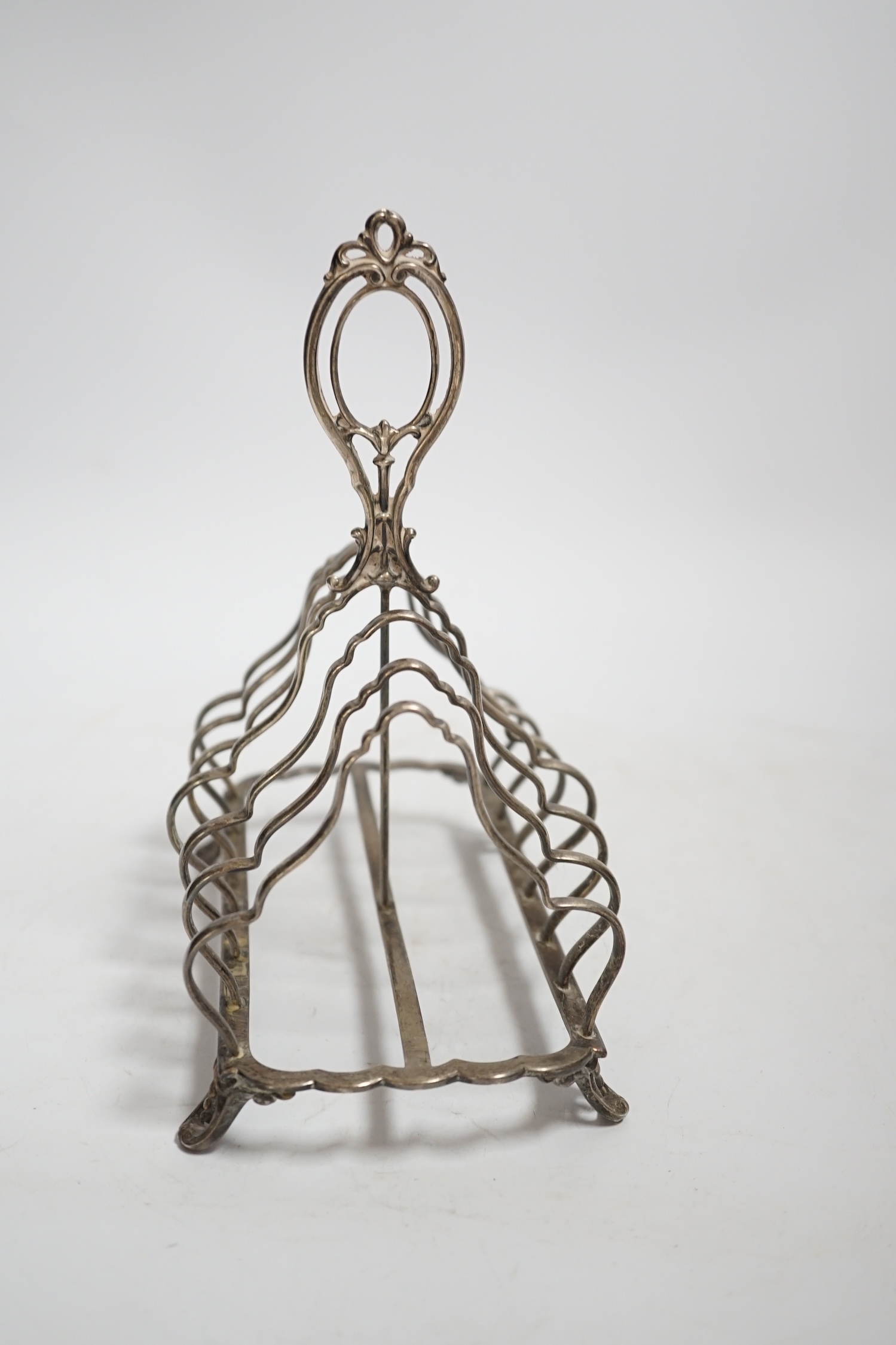 A Victorian silver seven bar toast rack, with loop handle, Henry Wilkinson & Co Ltd, Sheffield, 1874, length 18cm, 10oz.
